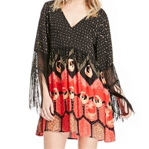 Fun and Flirty dress by MinkPink! Fun fringe on arms and has baby doll fit!